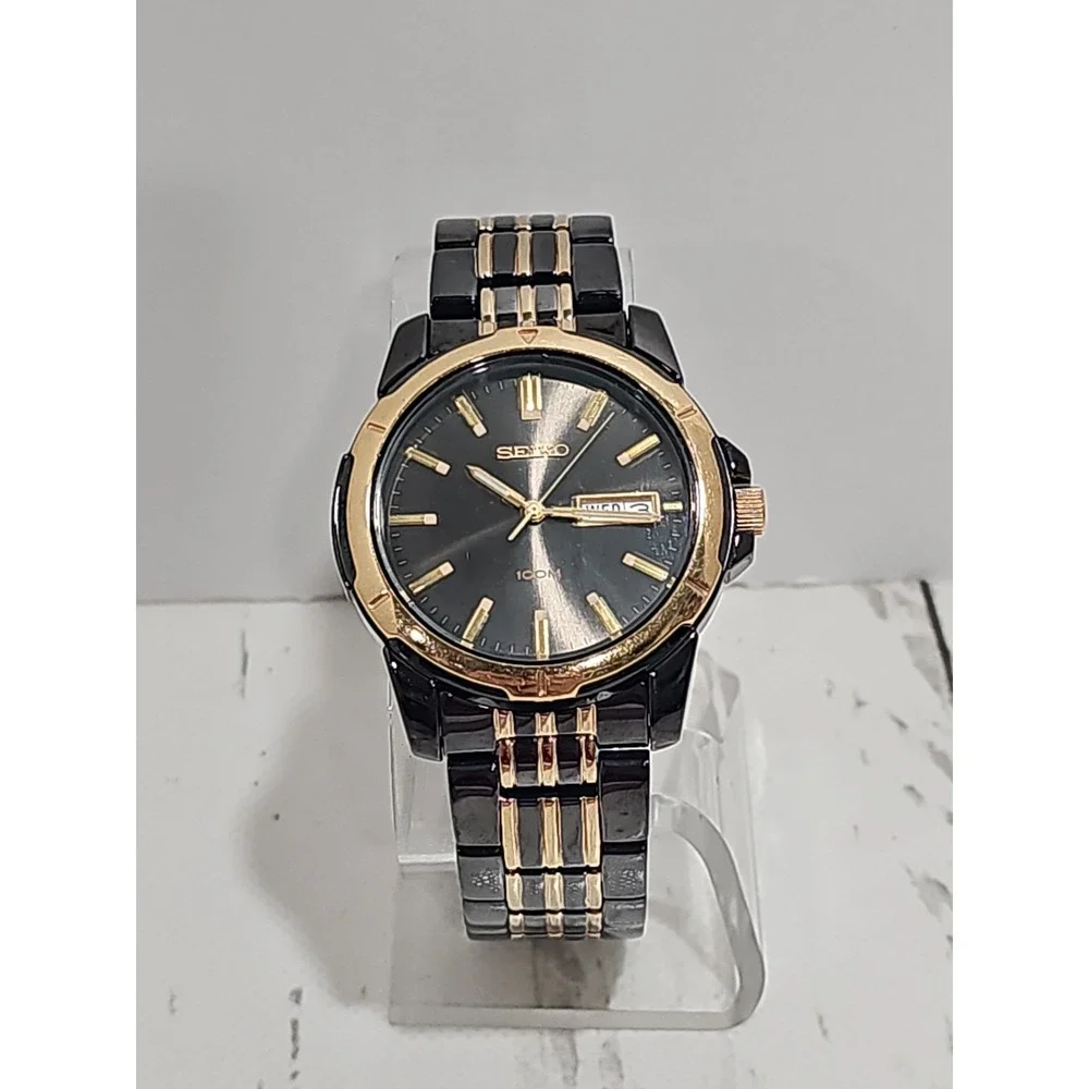 Seiko Quartz 100M watch (black and gold two-tone with day/date)